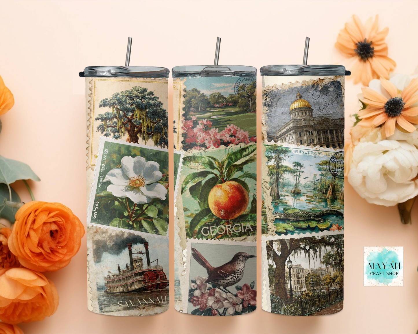 Three tumblers with scenic designs on a light pink background with flowers.
