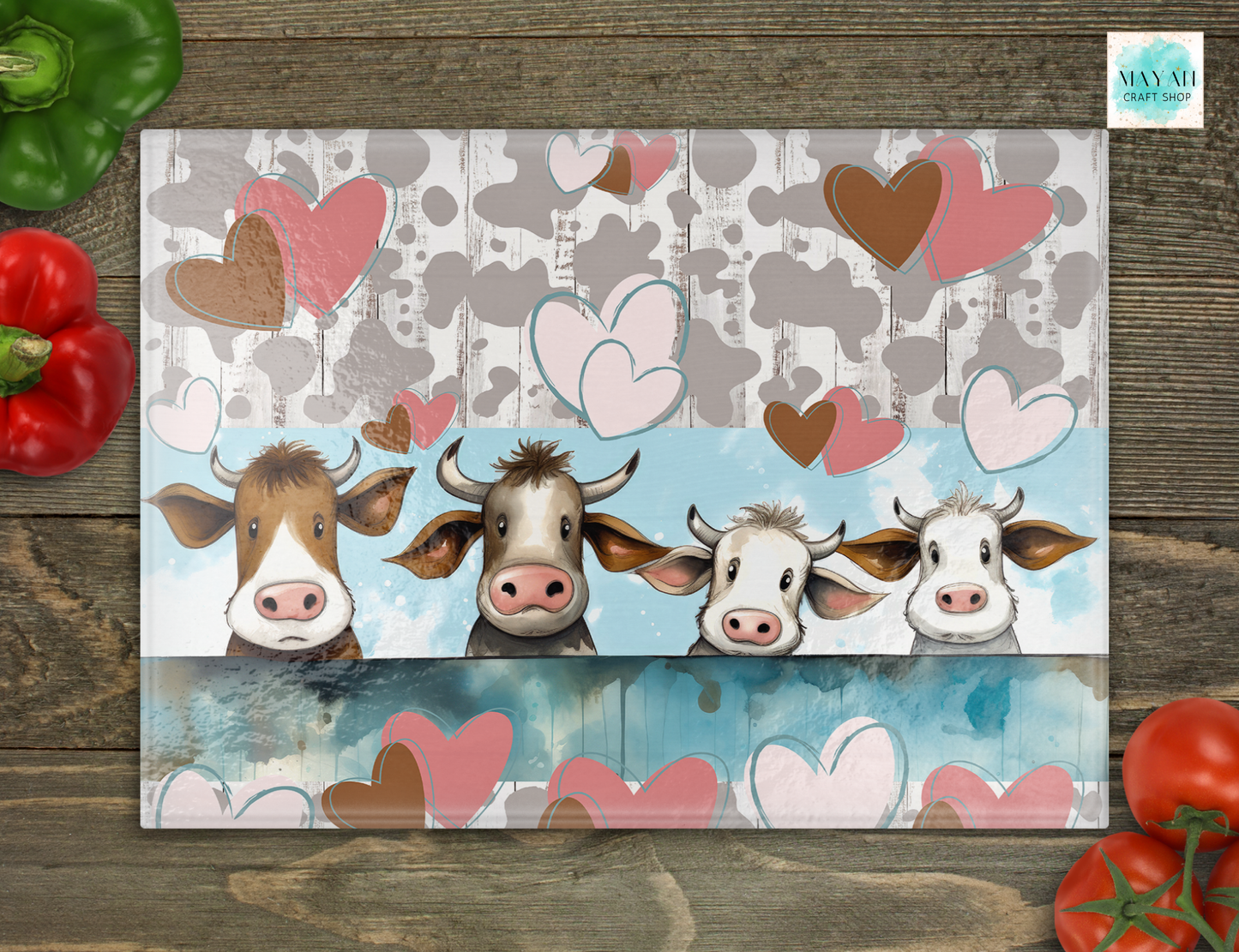 Cutting board with cartoon cows and hearts on a wooden surface
