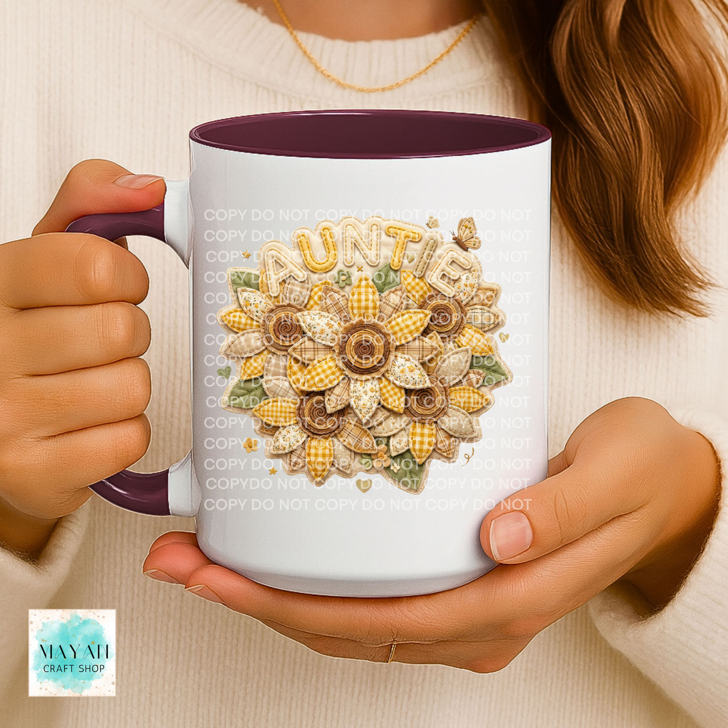 Person holding a mug with a floral design and 'Auntie' text.