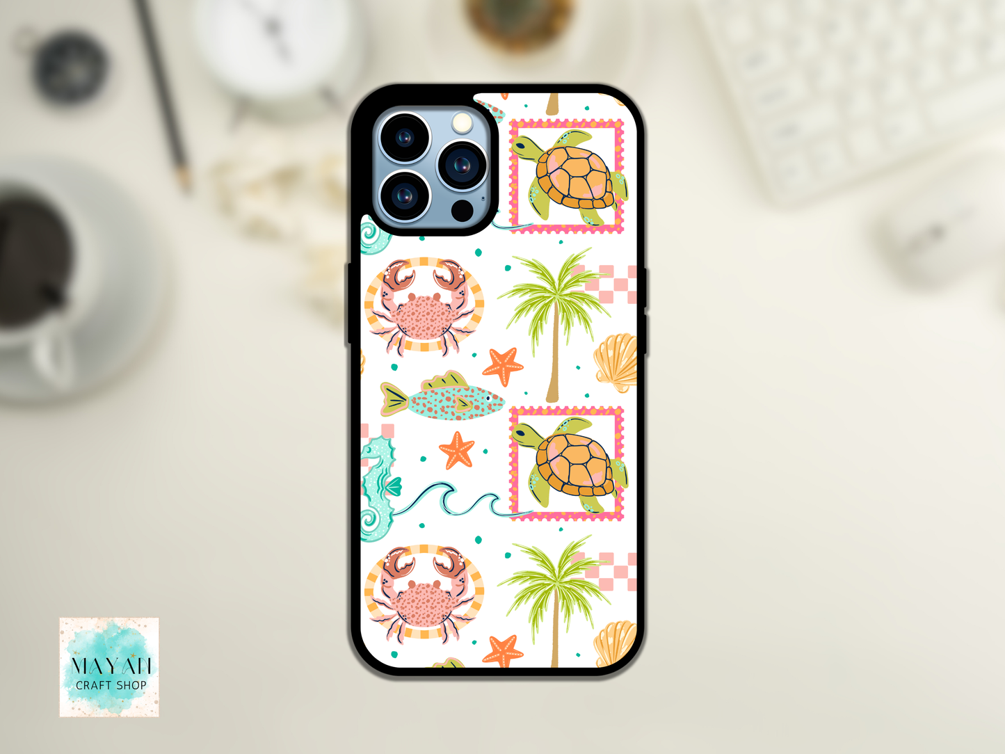 Phone case with sea-themed design featuring turtles, crabs, and palm trees on a white background.