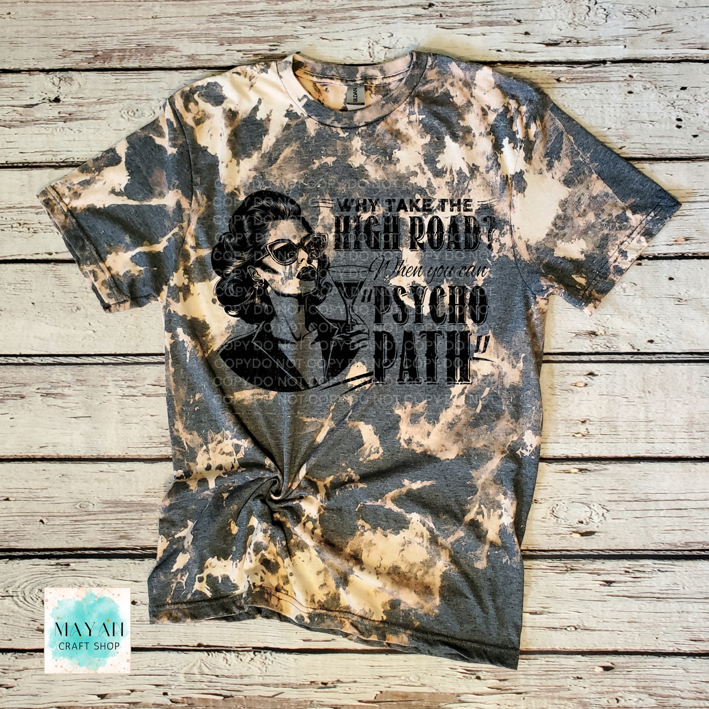 Bleached t-shirt with graphic design and text on a wooden surface
