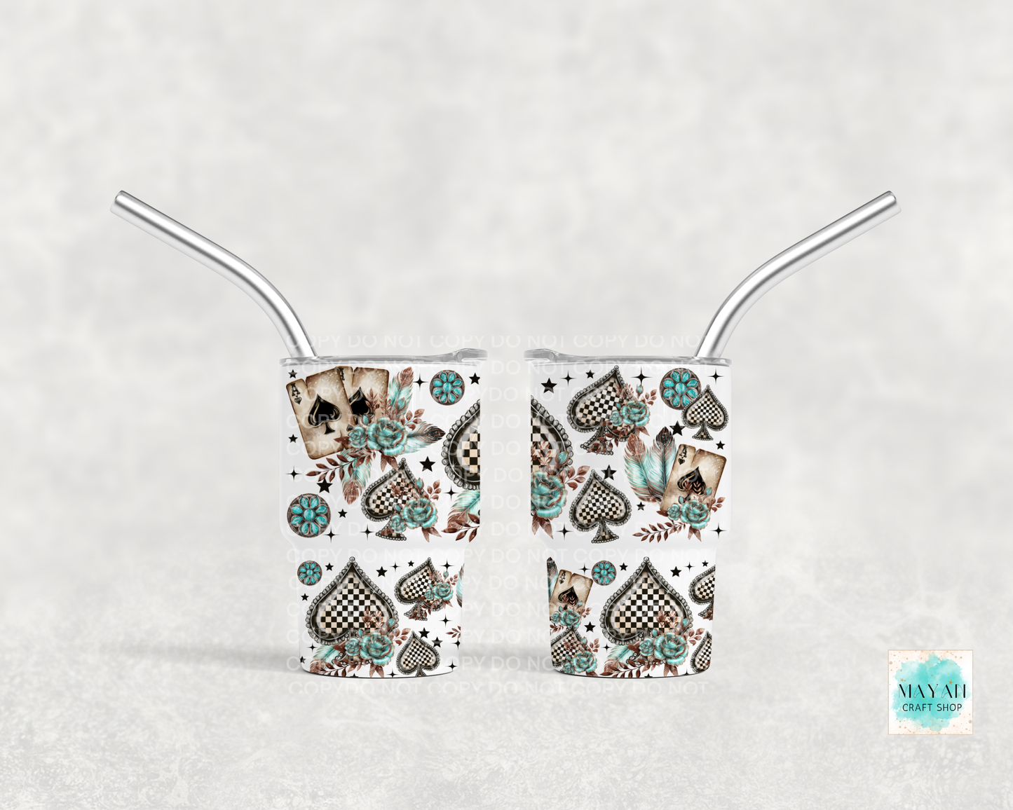 Two mini tumbler shot glasses with decorative patterns on a white background