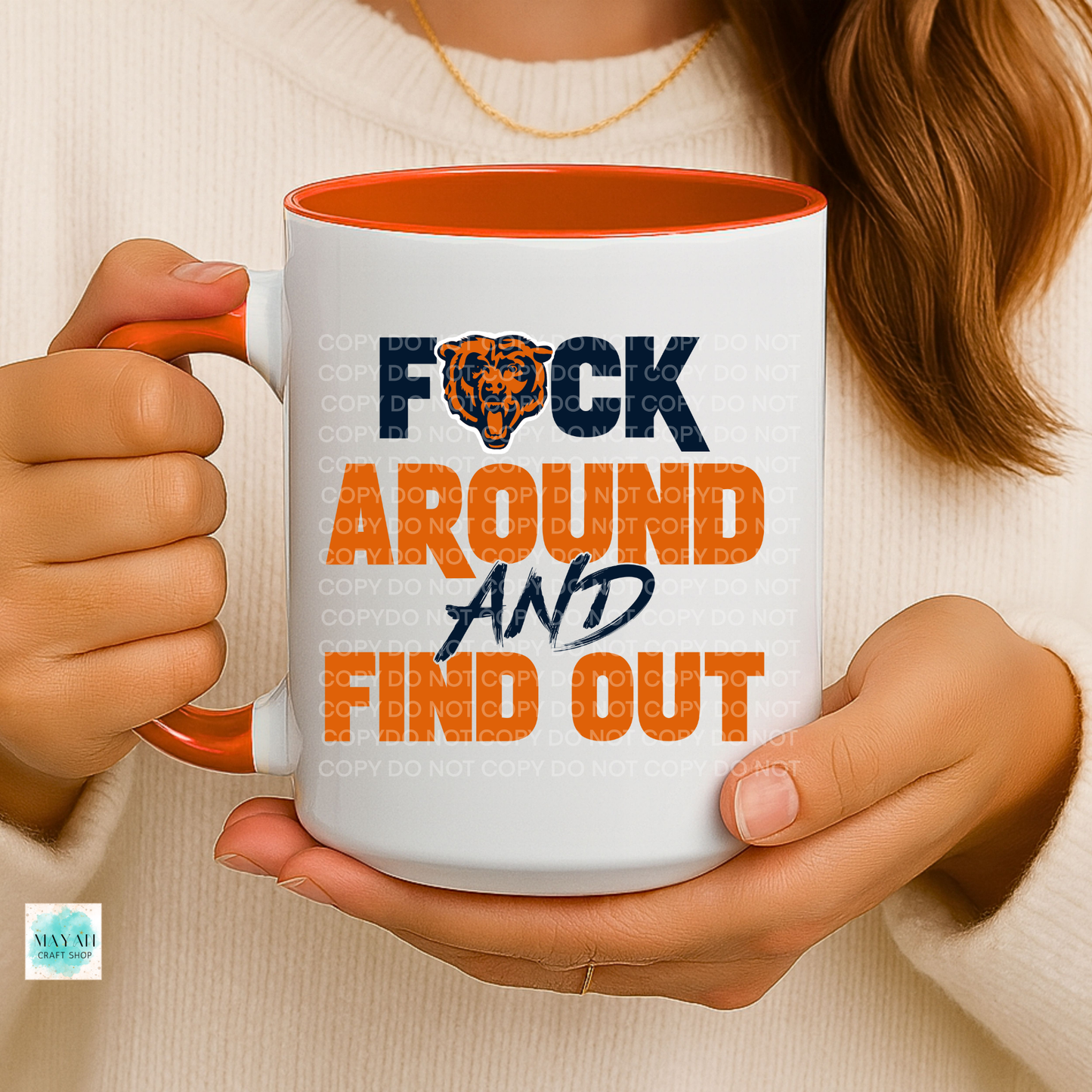 Person holding a mug with a graphic design and text.