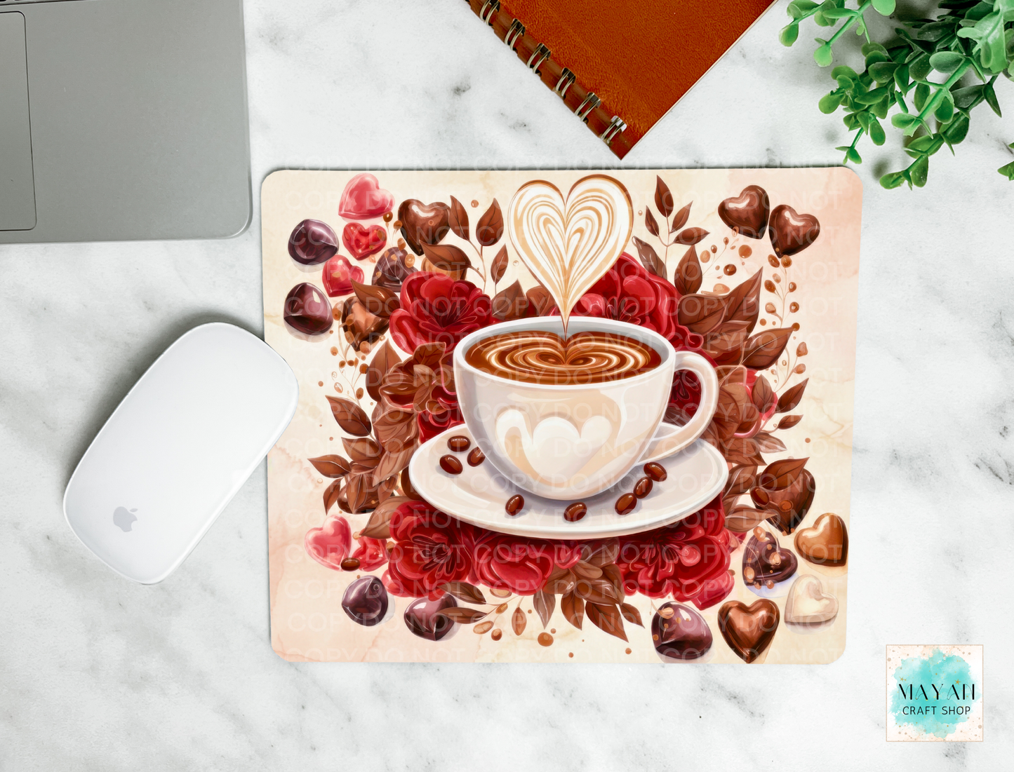 Decorative mouse pad with a coffee cup design on a marble surface.