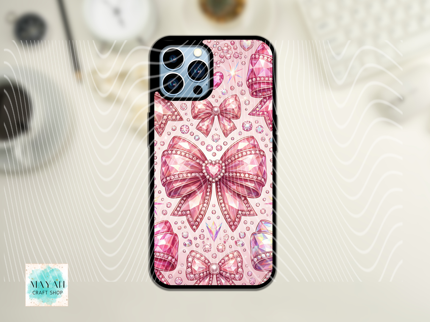 Phone case with pink bows and rhinestones on a light background