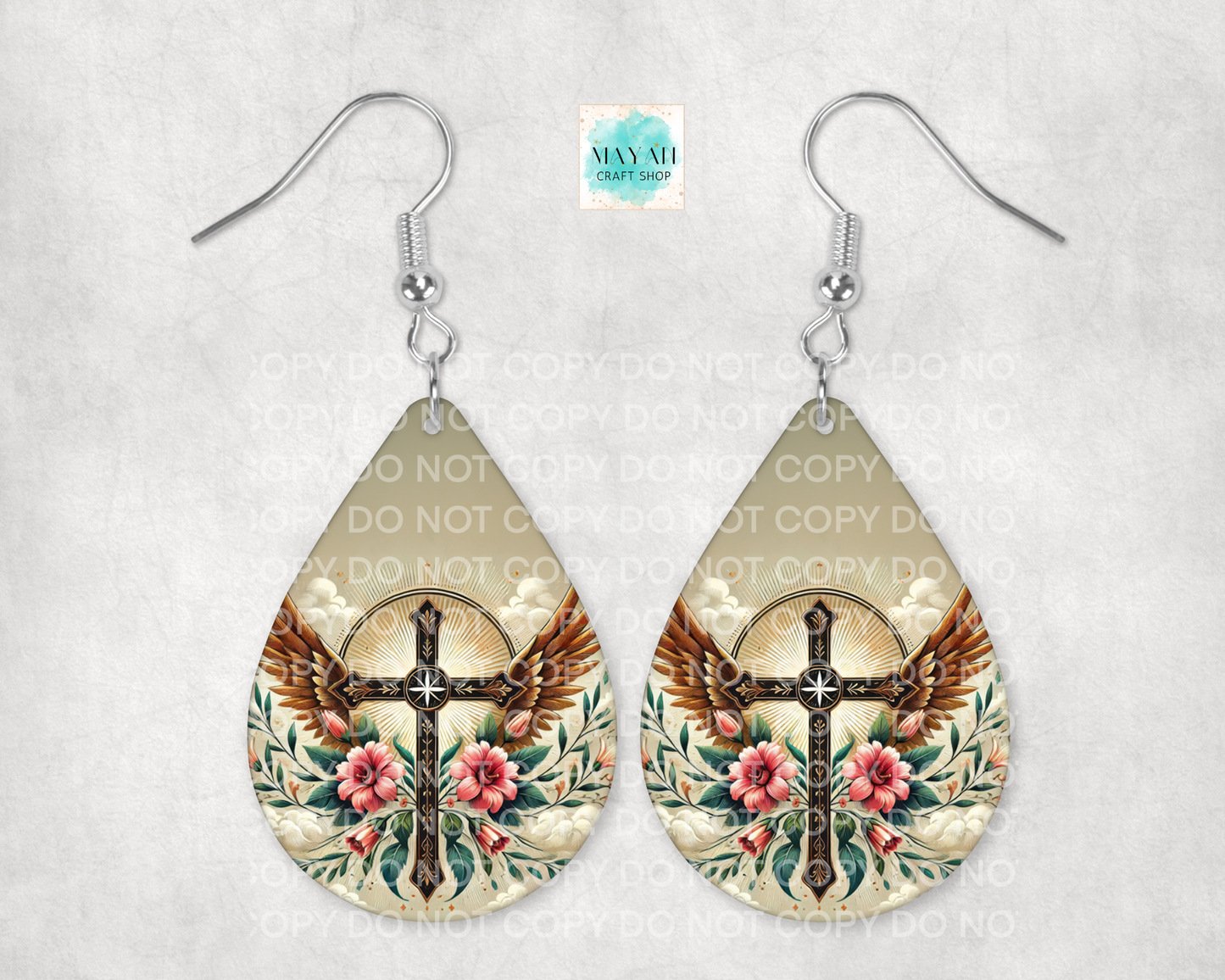 Teardrop-shaped earrings with cross and eagle design on a light background
