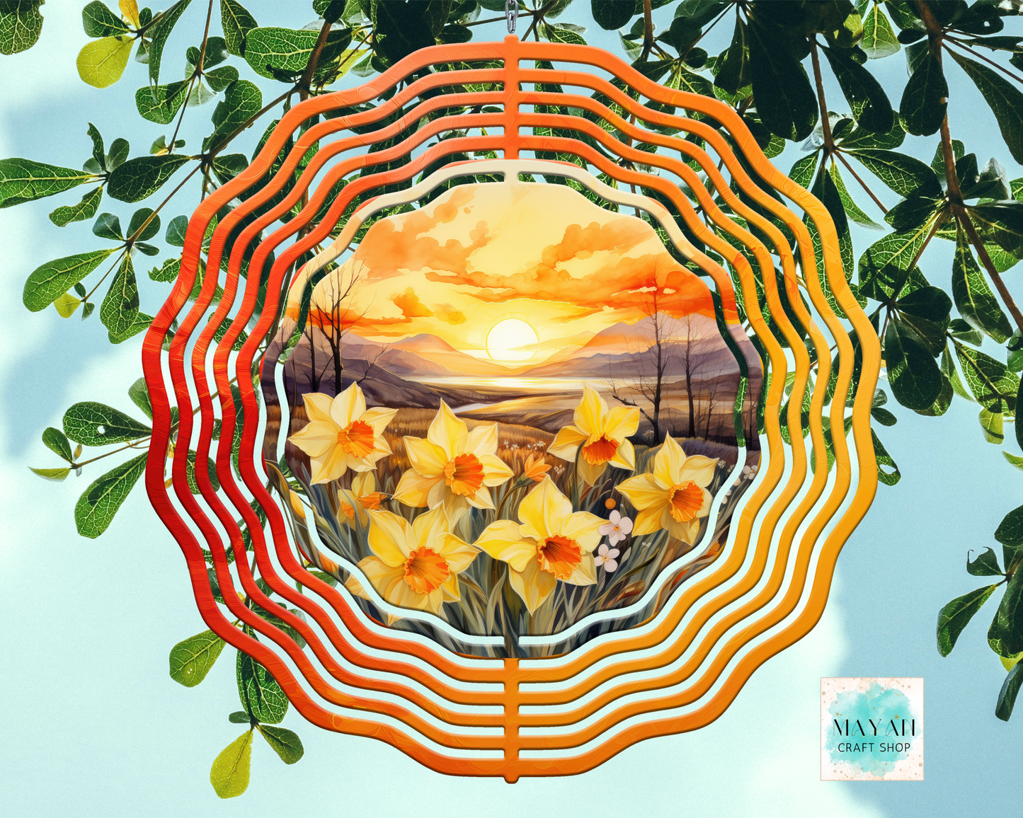 Decorative plate with a sunset and flower design, surrounded by green leaves.