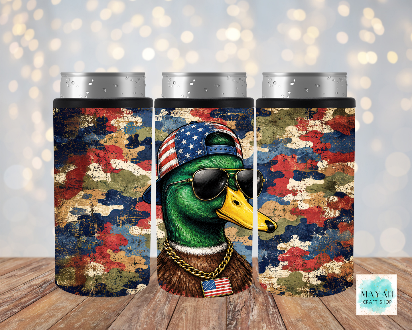 Three cylindrical can coolers with a duck wearing sunglasses and an American flag hat on a camouflage pattern.