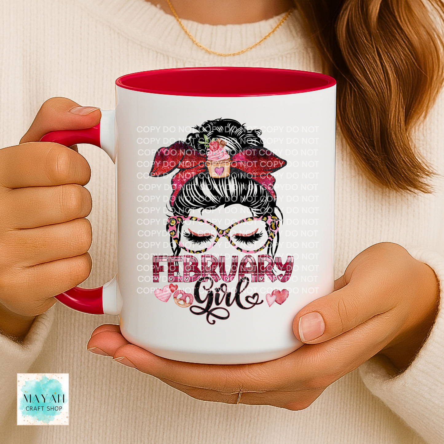 Person holding a mug with 'February Girl' design and red interior.