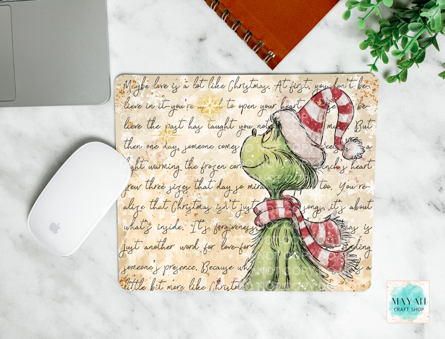 mouse pad with a Christmas text on a marble surface with a laptop and mouse.