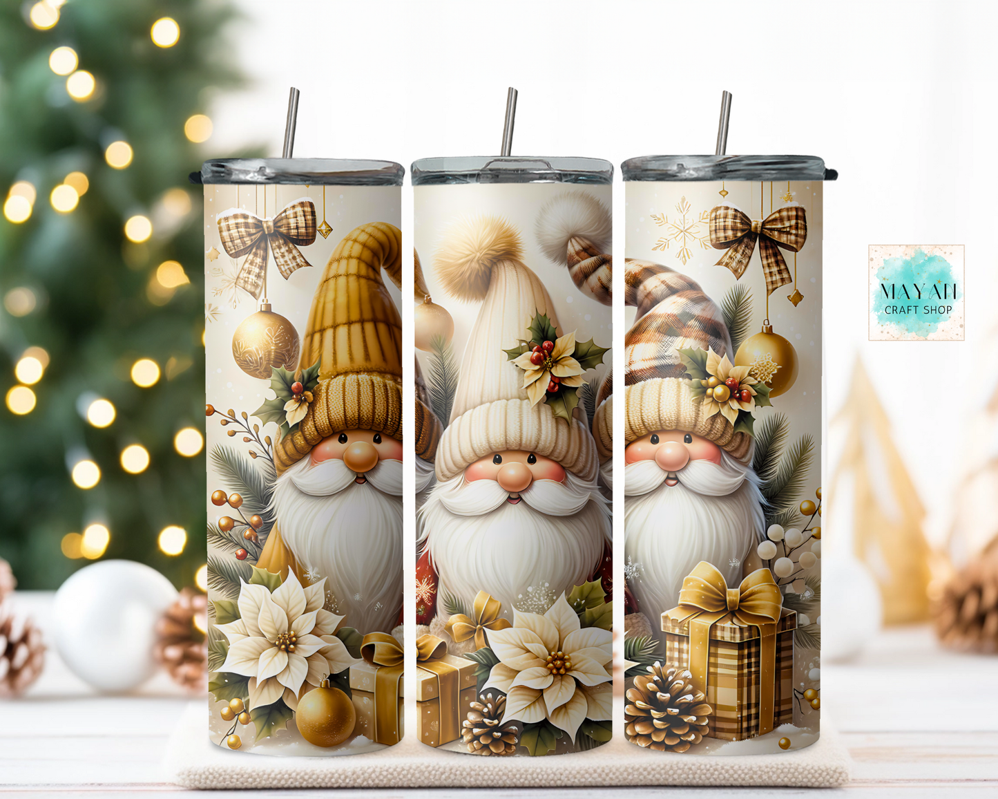 Three Christmas-themed tumblers with gnomes and ornaments on a decorative background.