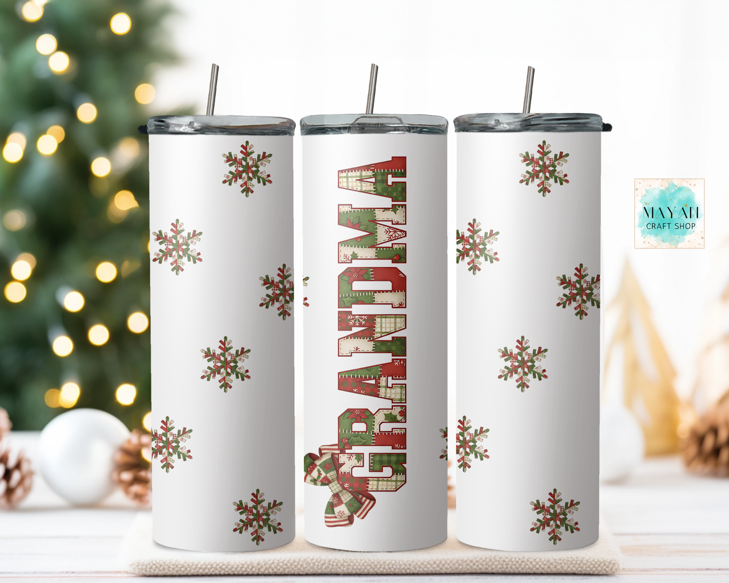 Three Christmas-themed tumblers with snowflakes and 'Grandma' text on a decorative surface.