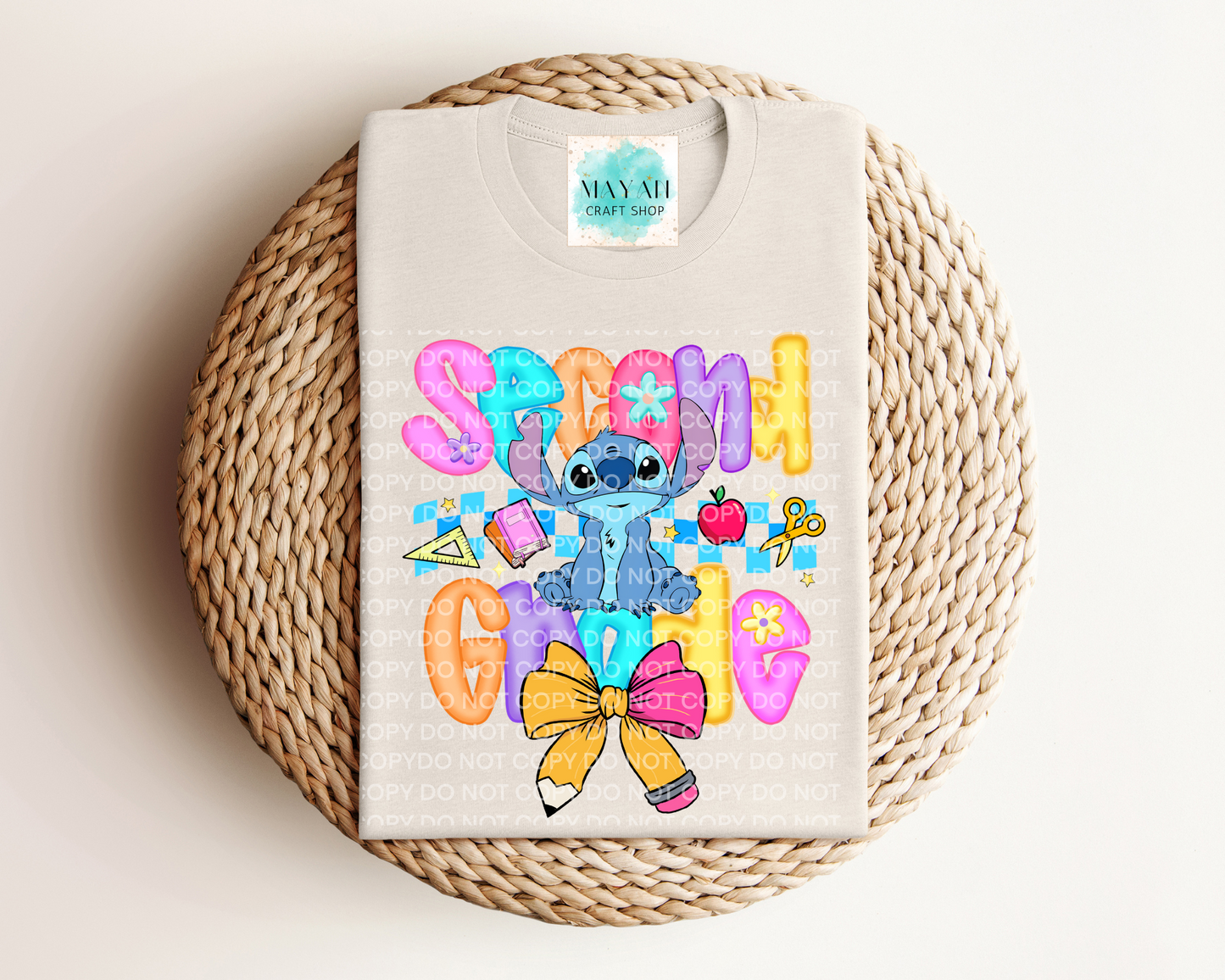 Heather dust shirt with colorful character design and text on a woven mat