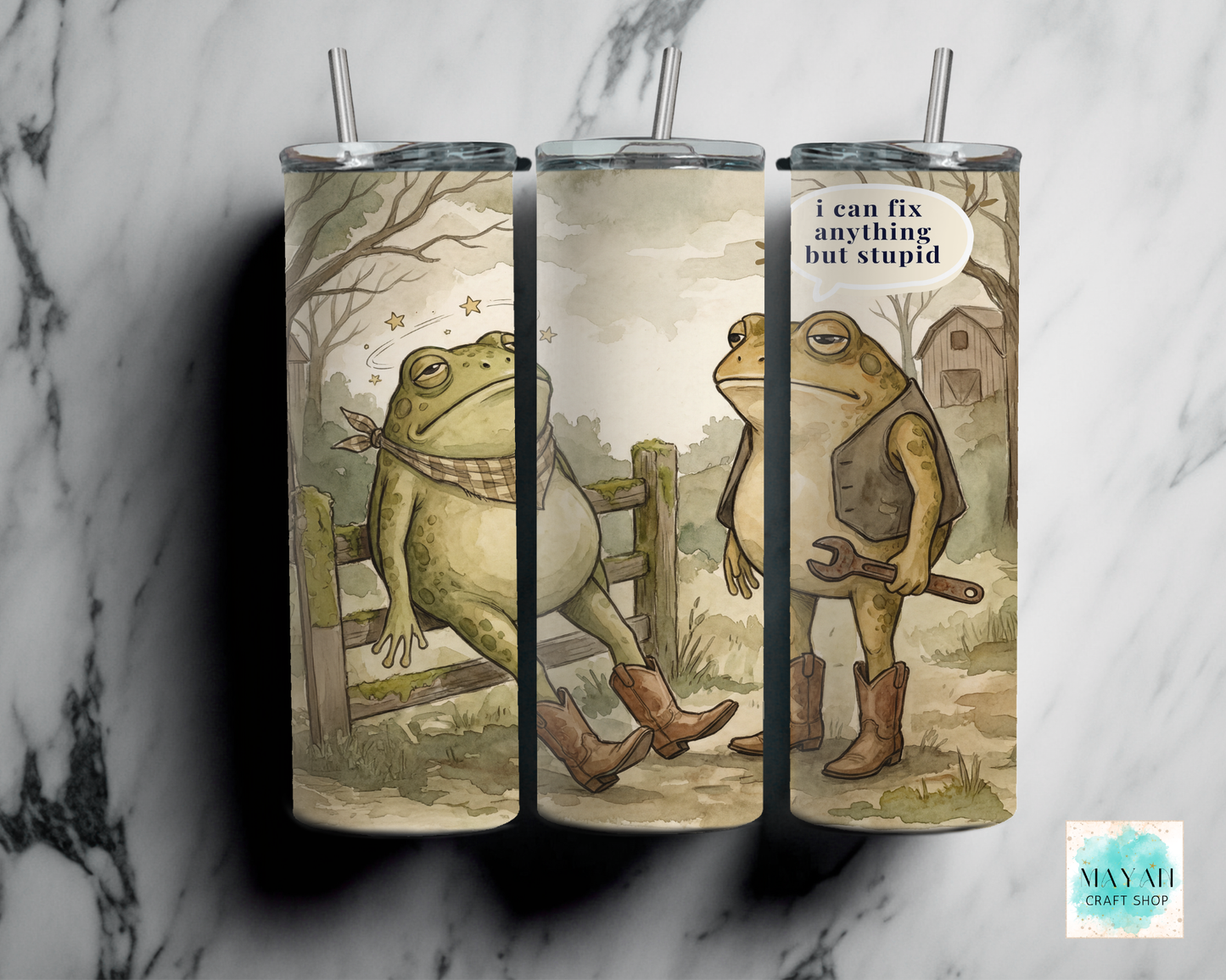 Three tumblers with frog designs on a marble surface, featuring text and rustic elements.