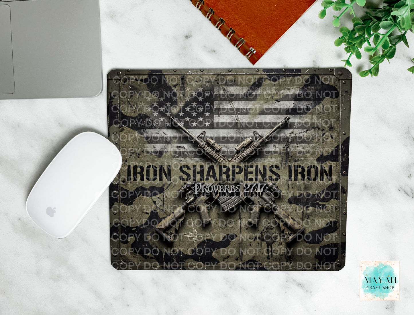 Metal sign with American flag design and text on a marble surface