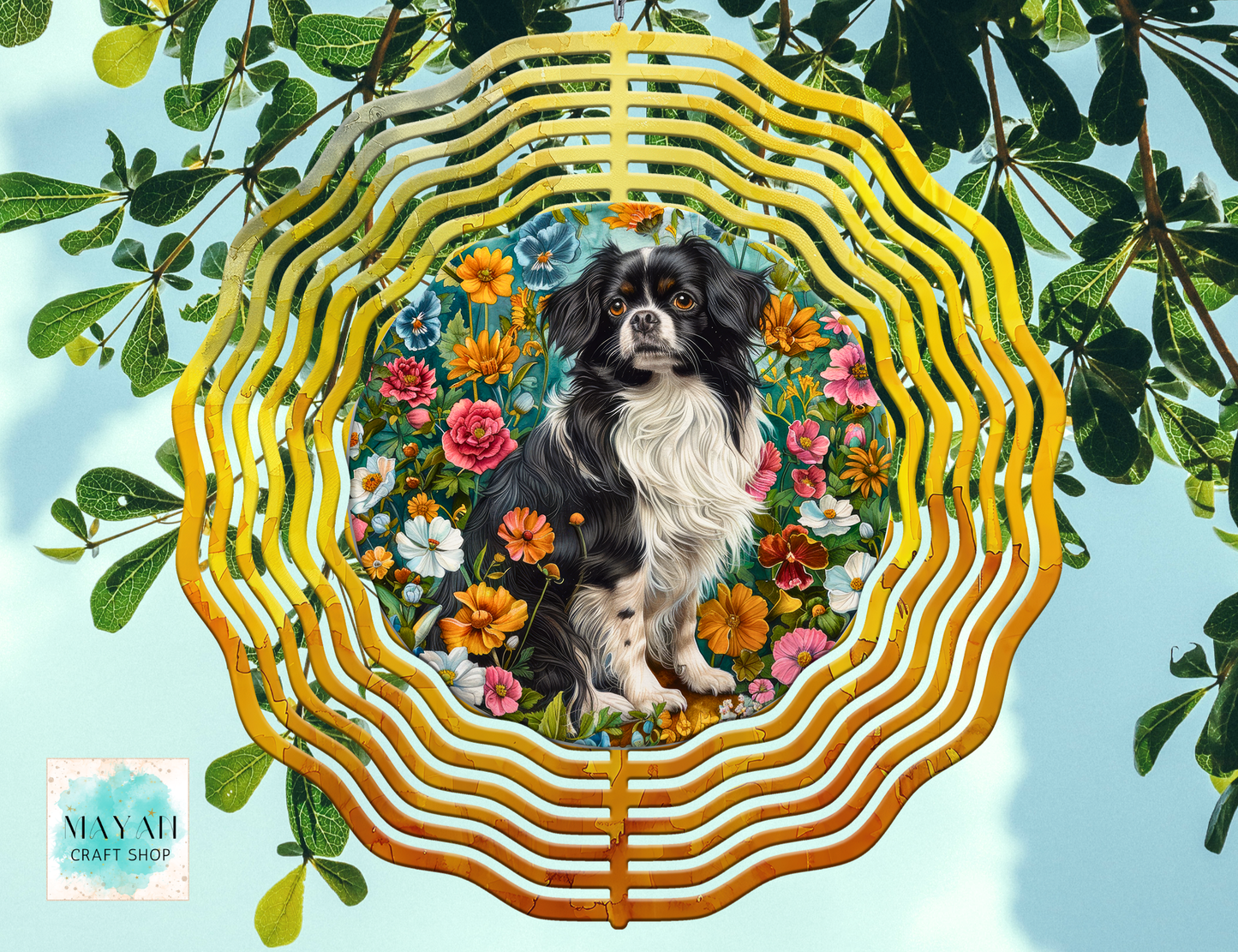 Dog surrounded by flowers and leaves in a decorative wind spinner