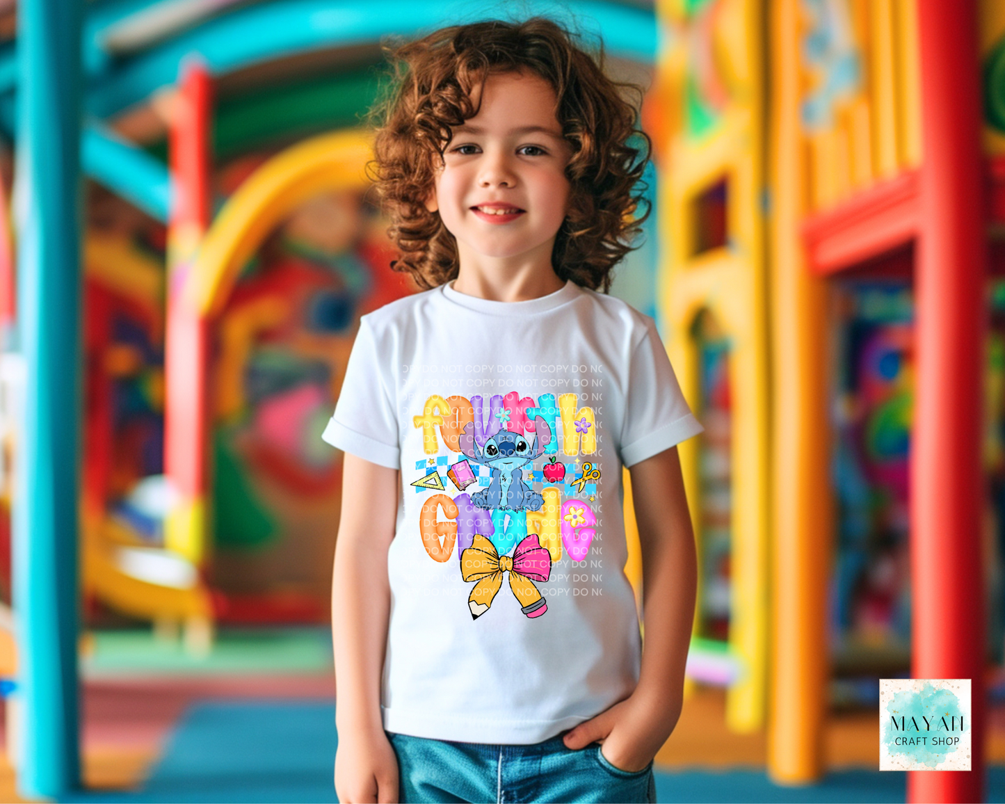 Child wearing a colorful t-shirt with cartoon character design in an outdoor playground setting