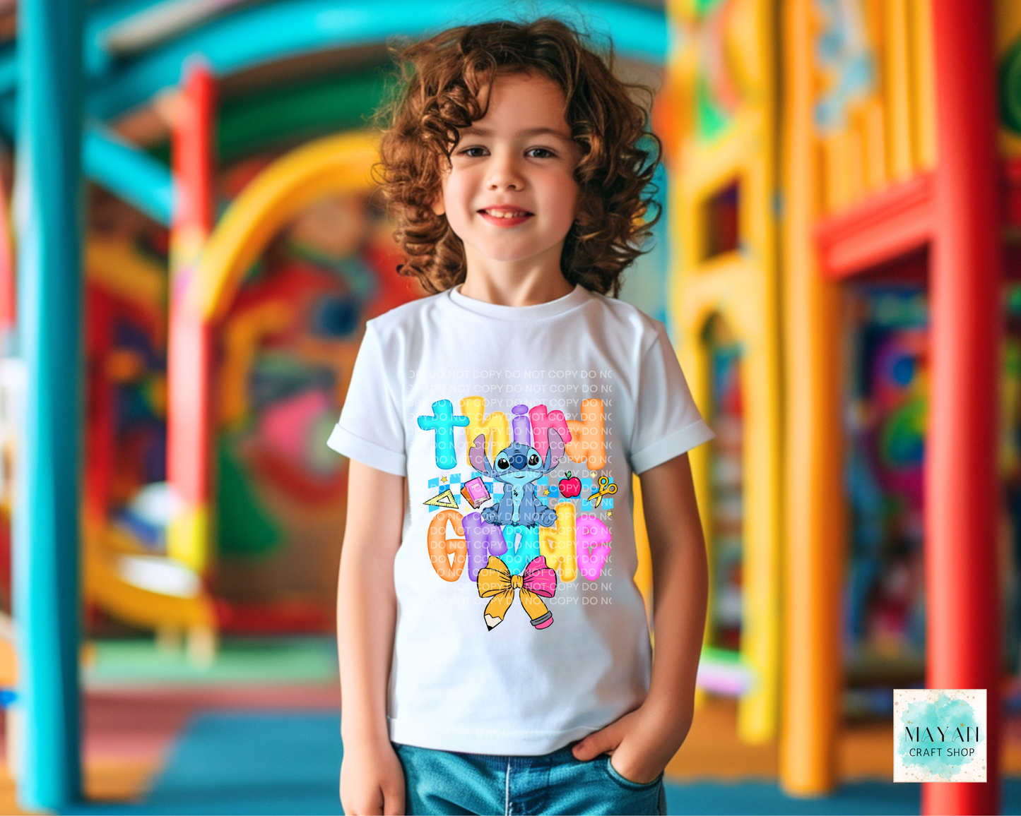 Child wearing a colorful t-shirt with cartoon character in a playground setting