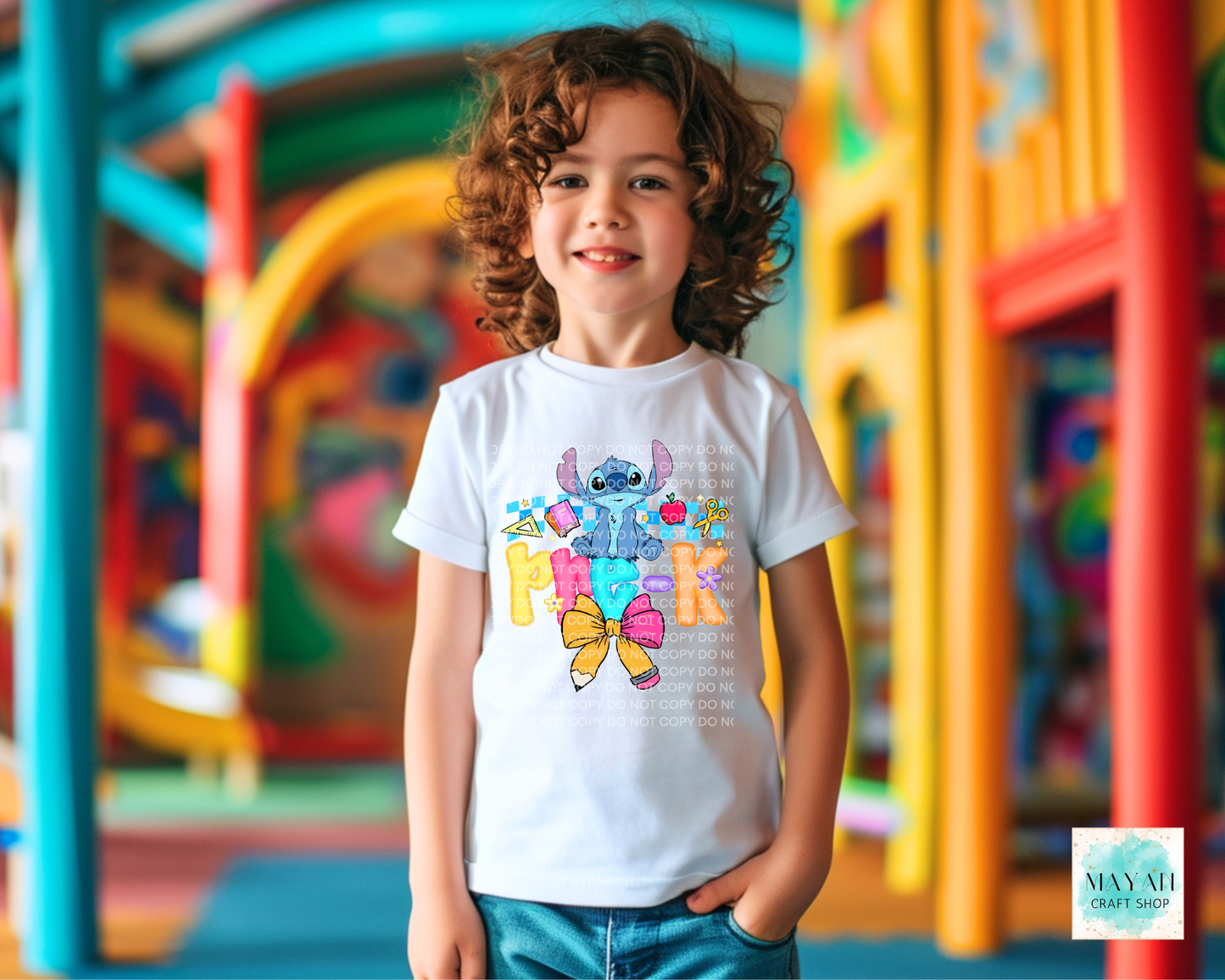 Child wearing a colorful t-shirt with cartoon characters in an outdoor playground setting