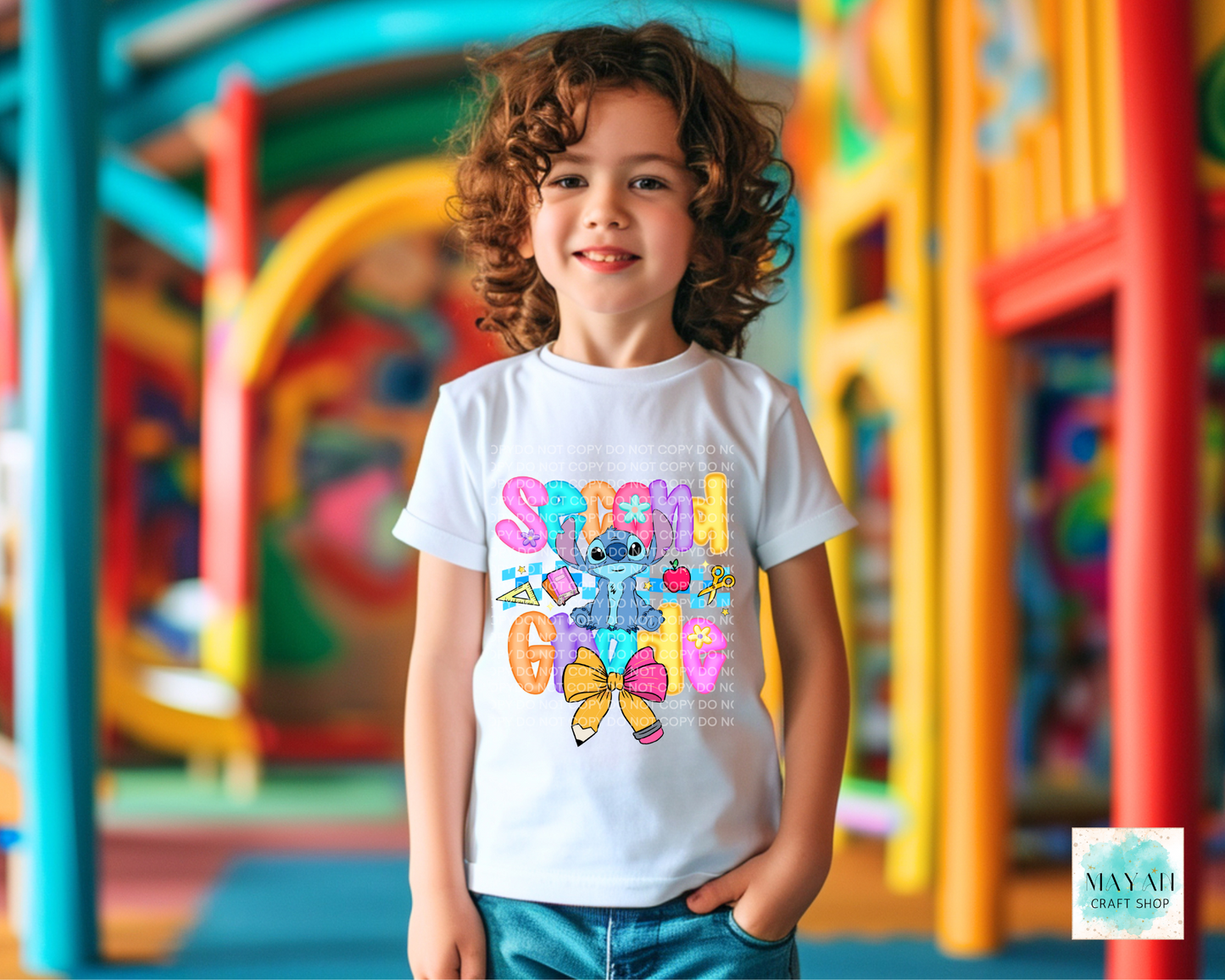 Child wearing a colorful t-shirt with cartoon character design in an outdoor setting