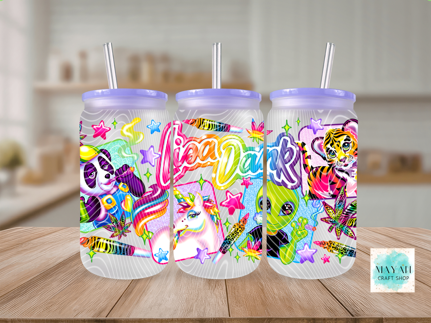 Three colorful tumbler with lids and straws on a wooden table.