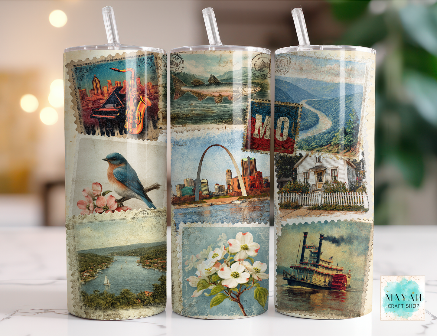 Set of three cylindrical tumbler with vintage-style designs on a blurred background