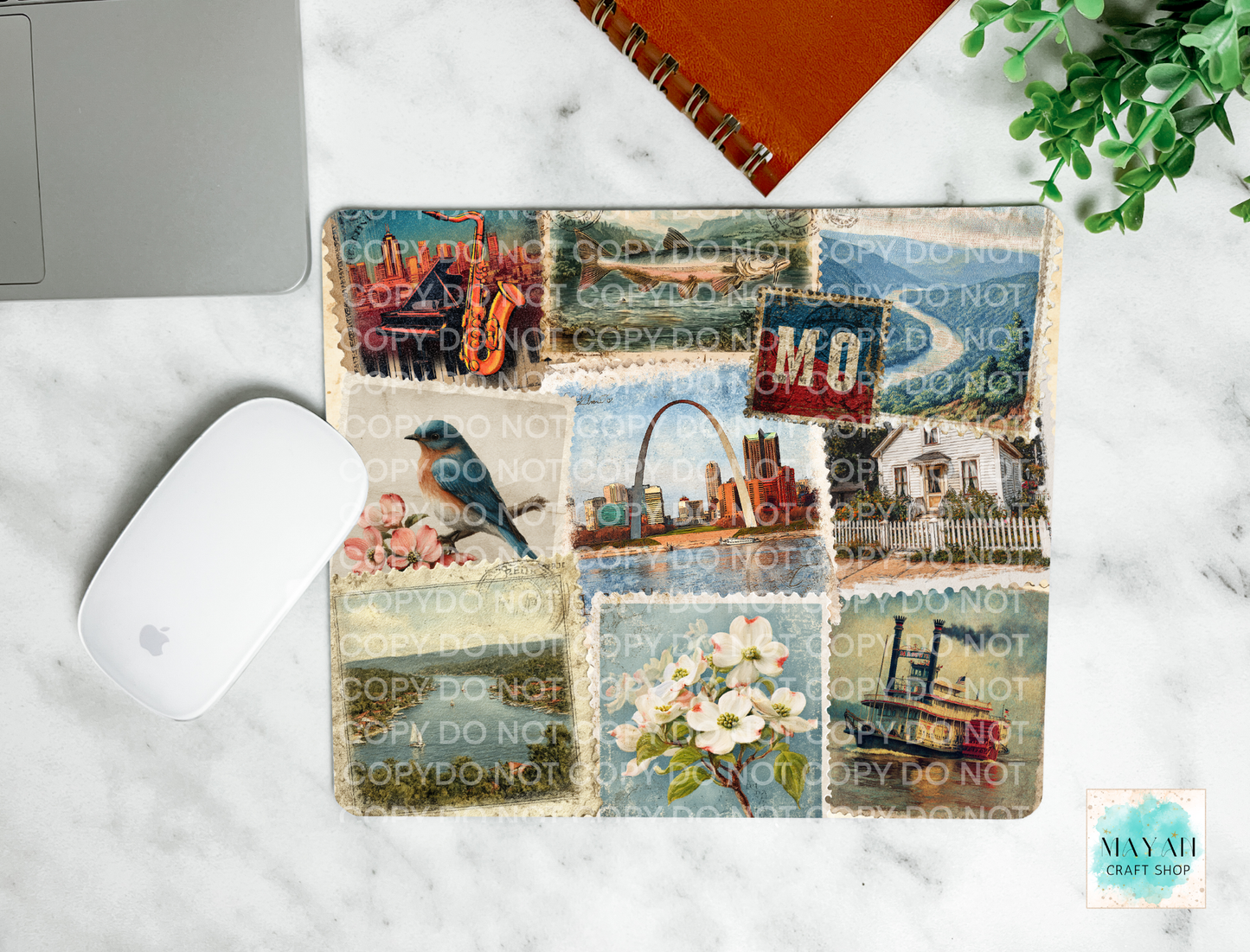 Collage of scenic and nature-themed mouse pad on a marble surface with a laptop and mouse.