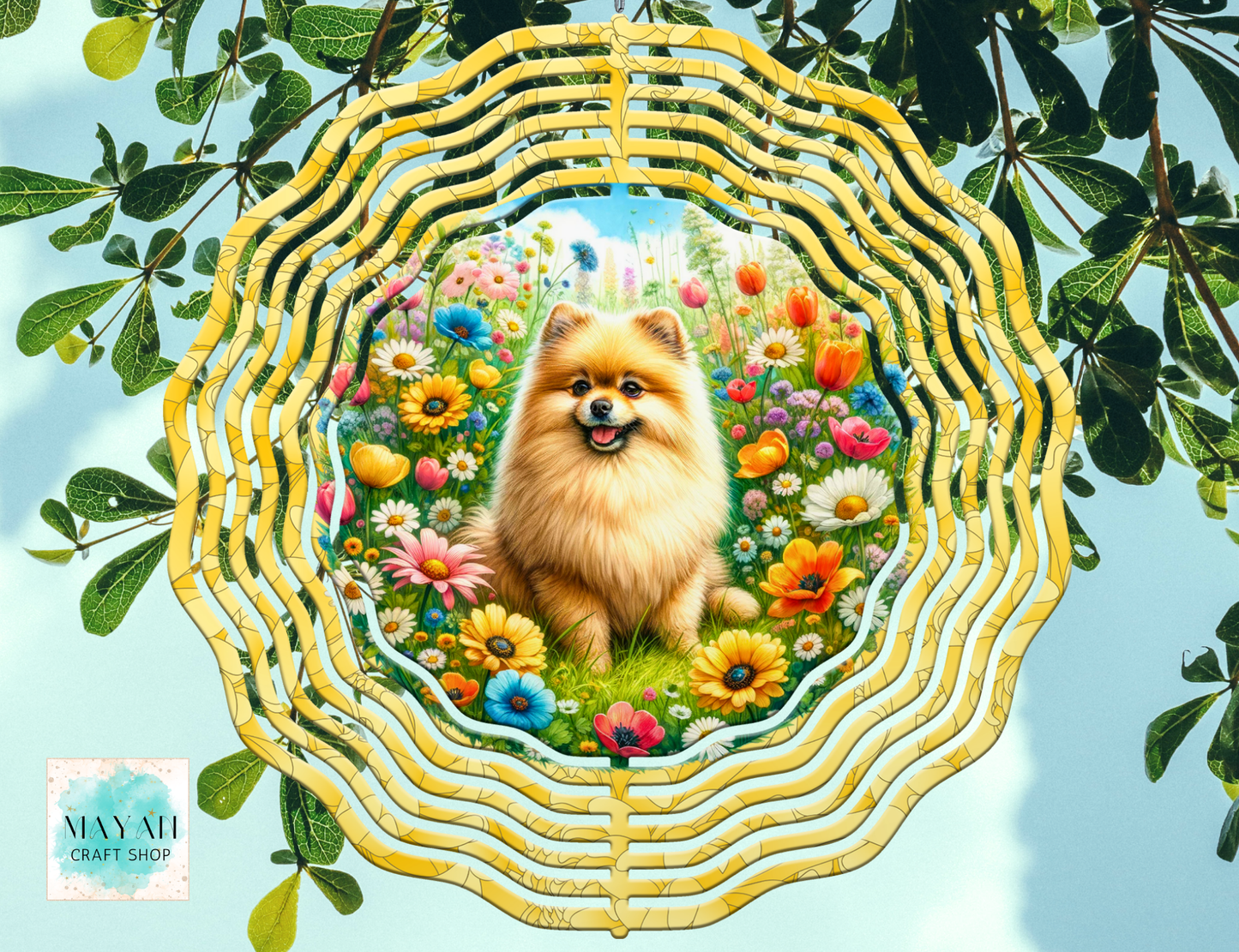 Decorative wind spinner with a dog surrounded by flowers and leaves.