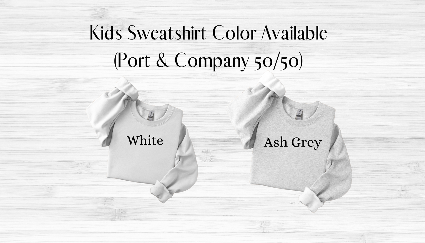 Two kids sweatshirts, one white and one ash grey, on a light wooden background with text indicating color options.