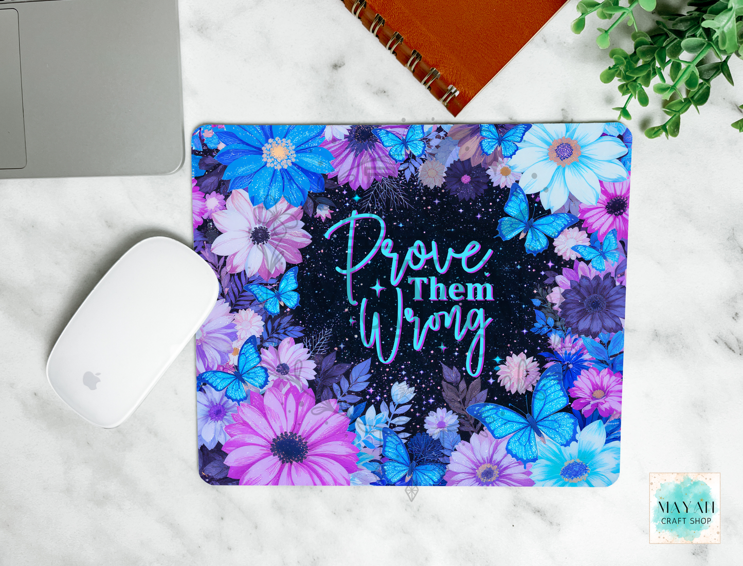 Floral mouse pad with motivational text on a marble surface