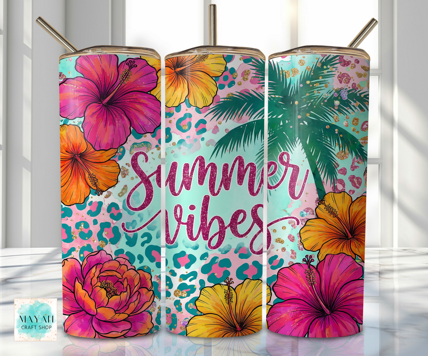Three colorful tumblers with floral and palm tree designs on a white background.