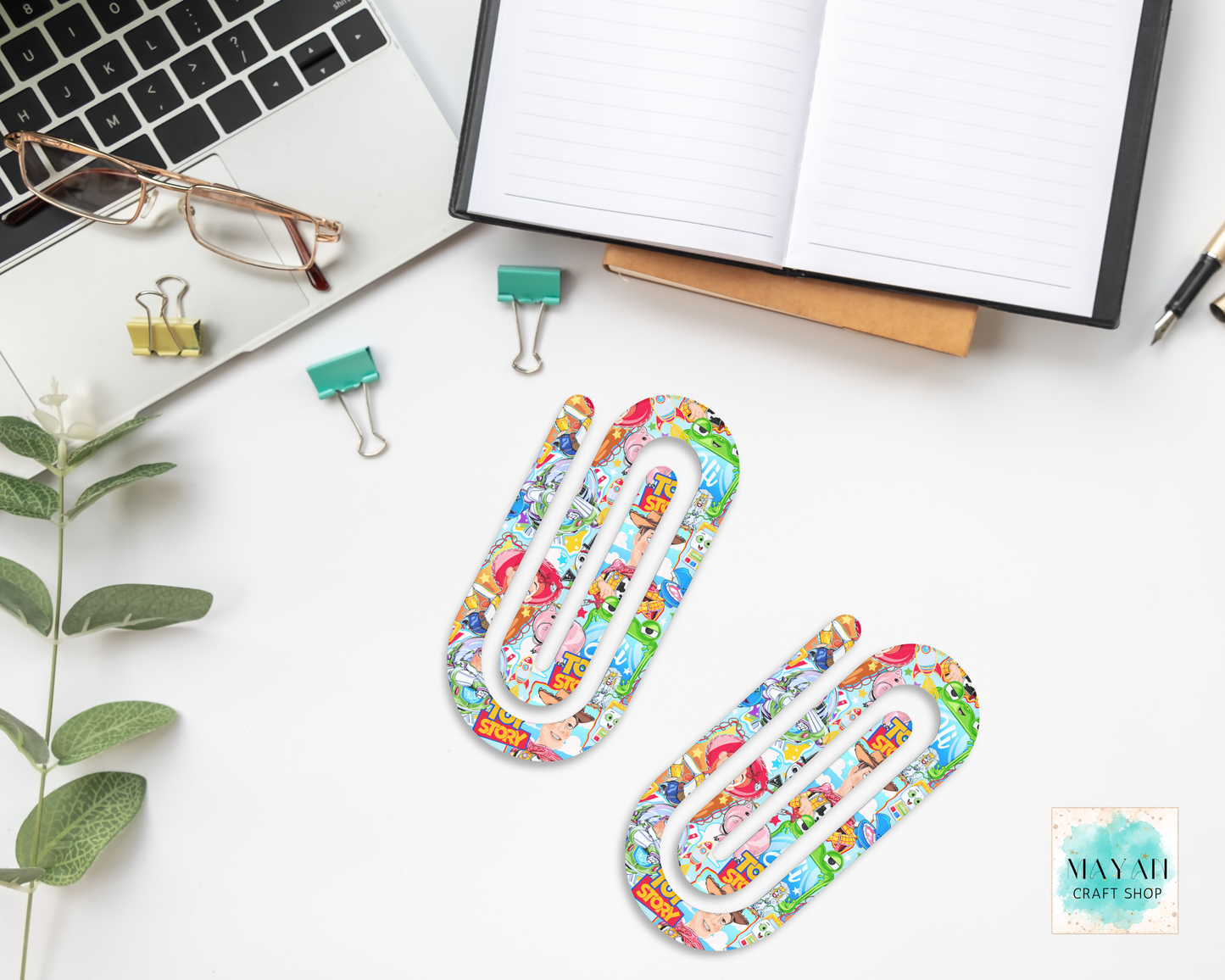 Colorful paper clips on a desk with office supplies