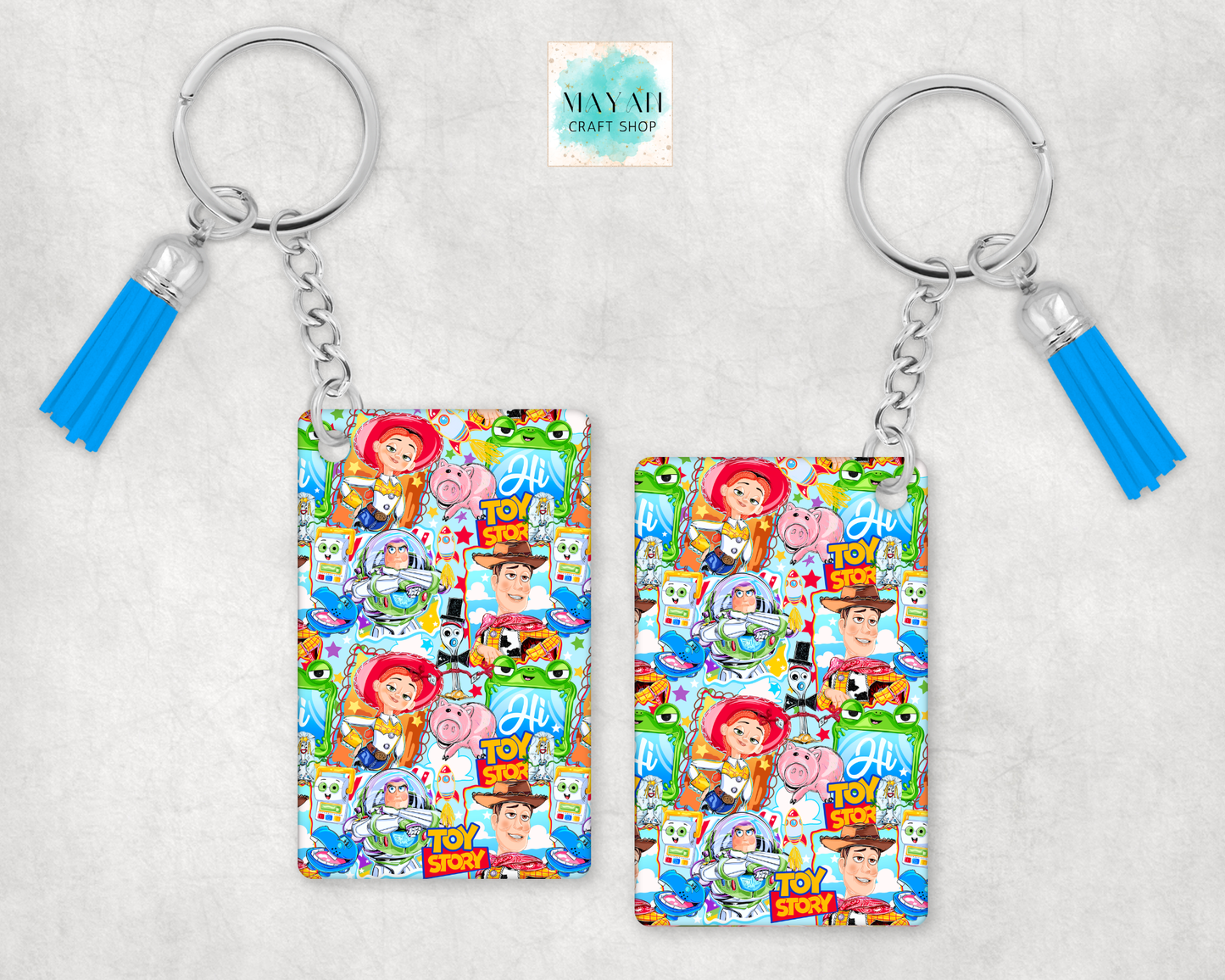 Two keychains with colorful designs featuring characters on a light gray background.