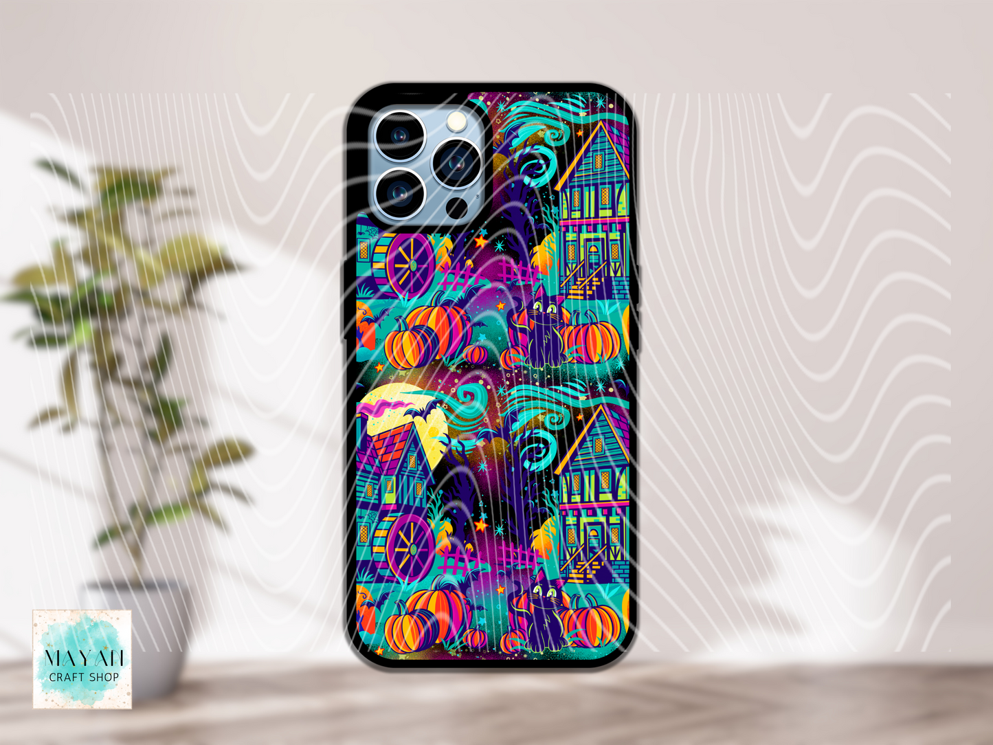 Colorful phone case with Halloween-themed design on a light background