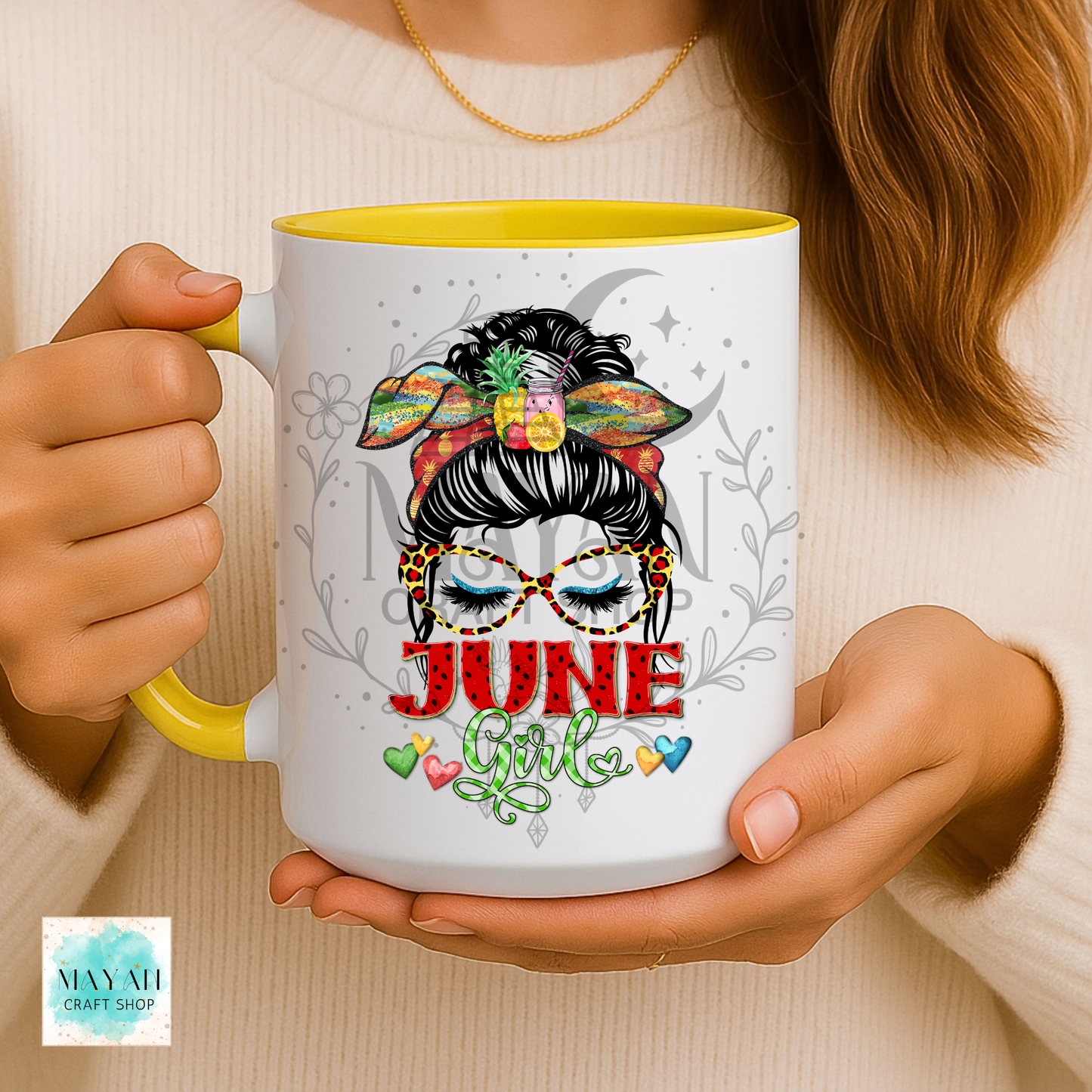 Person holding a mug with 'June Girl' design and colorful graphics.