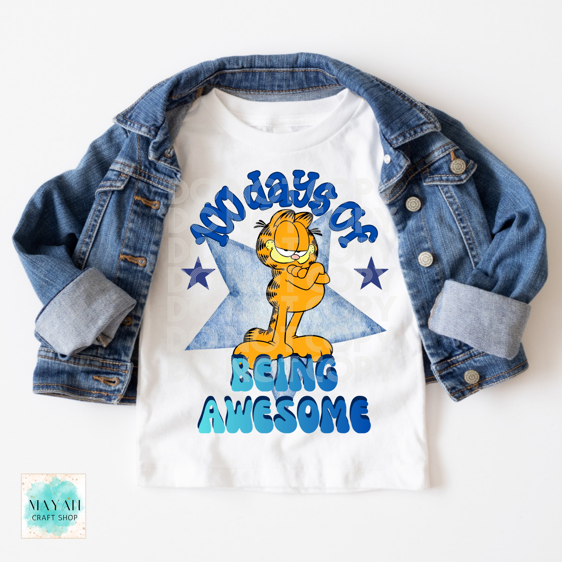 White t-shirt with cat graphic and text '100 days of being awesome' on a denim jacket.