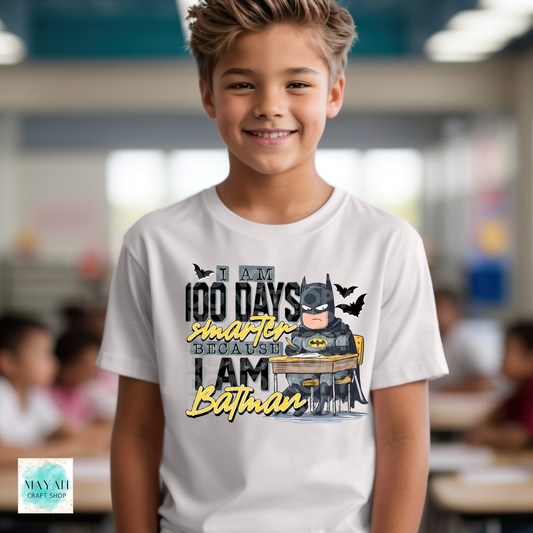 Child wearing a t-shirt with superhero graphic and text in a classroom setting