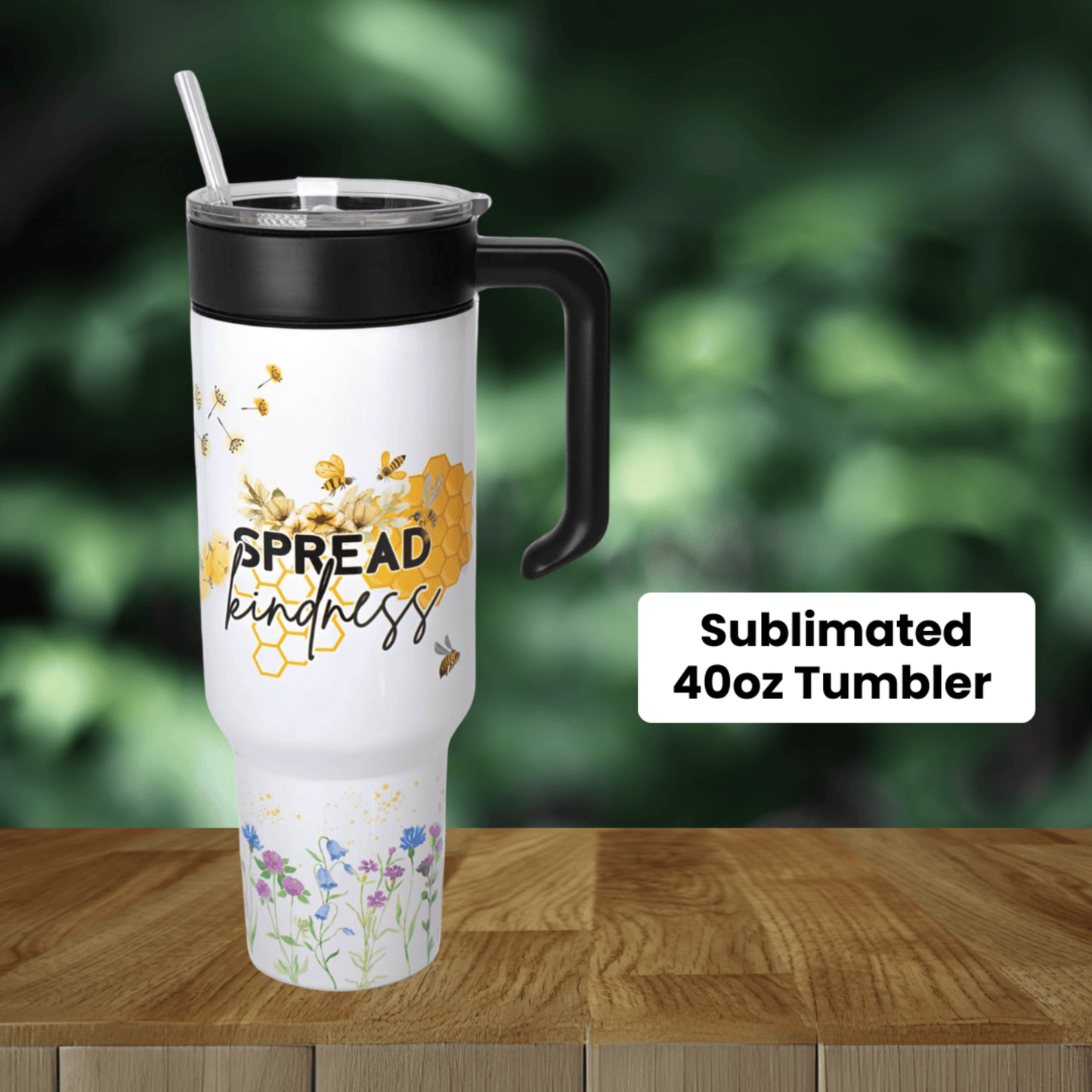 Sublimated 40oz tumbler on a wooden surface with a blurred green background.