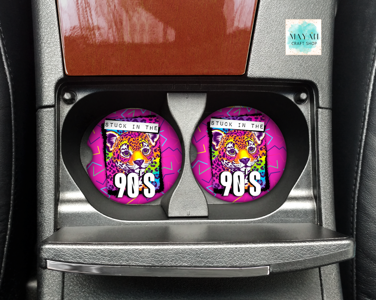 Two circular car cup holders featuring a colorful graphic of a leopard with the text 'STUCK IN THE 90'S' and a pink background, installed in a car's center console.
