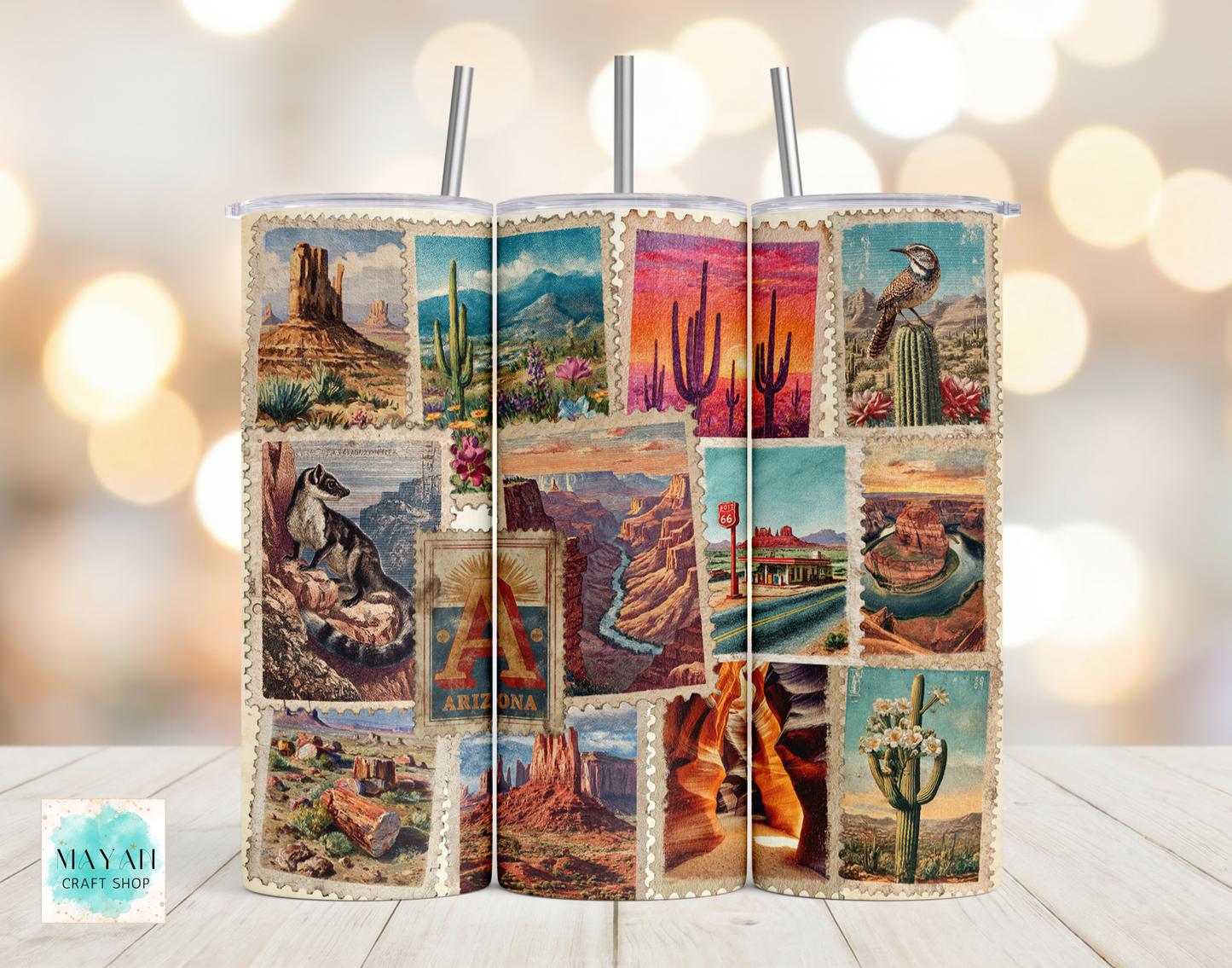 Two tumblers with desert-themed designs on a wooden surface with a blurred light background.