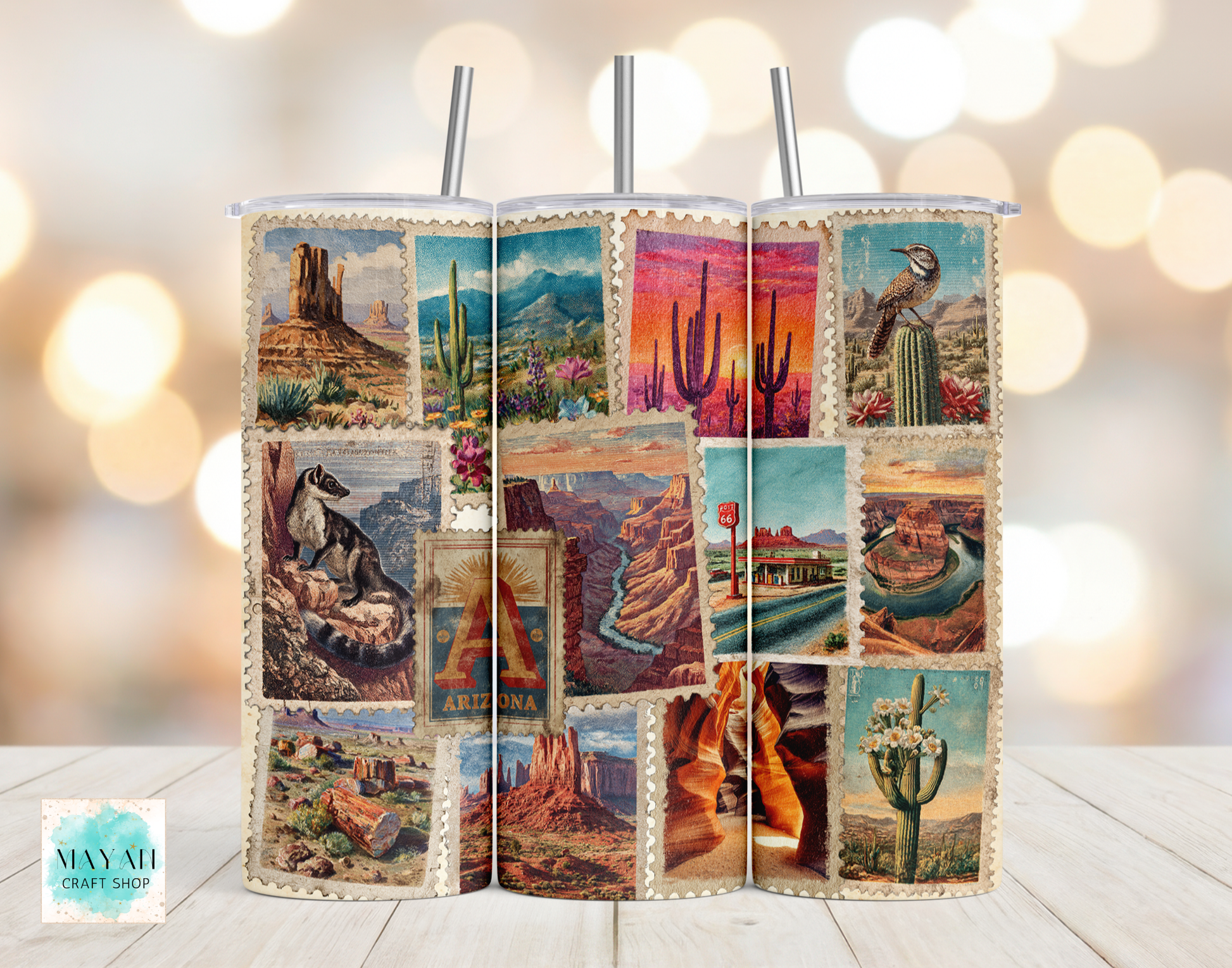 Two tumblers with desert-themed designs on a wooden surface with a blurred light background.