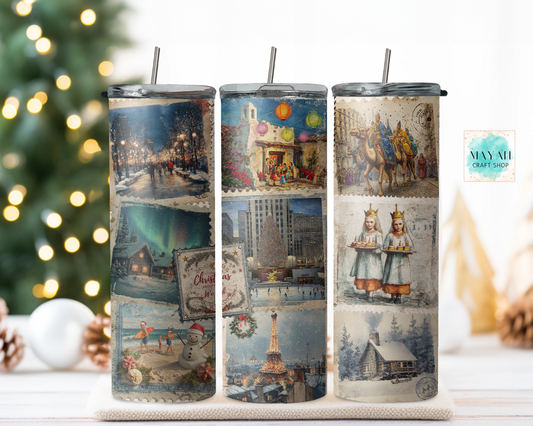 Three tumblers with vintage-themed designs on a surface with a Christmas tree in the background.