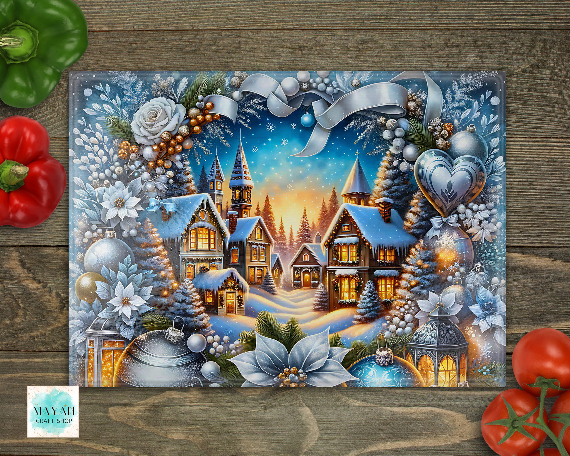 Decorative cutting board with a winter village scene, surrounded by vegetables on a wooden surface.