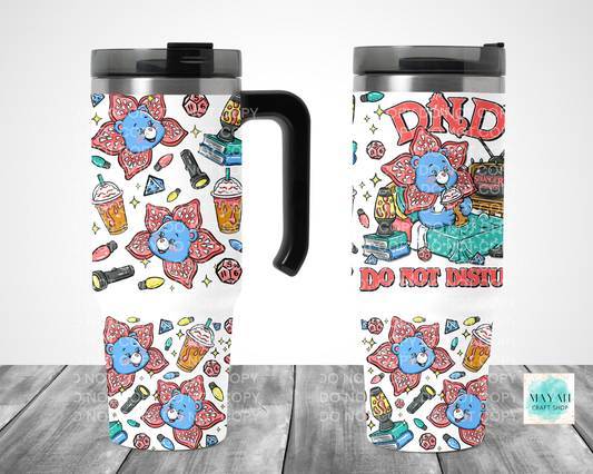 Two travel mugs with colorful designs featuring cartoon characters and text on a white background.