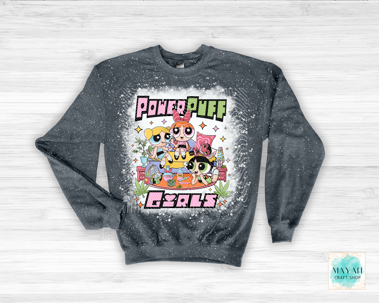 Gray sweatshirt with vibrant graphic on a light wooden background