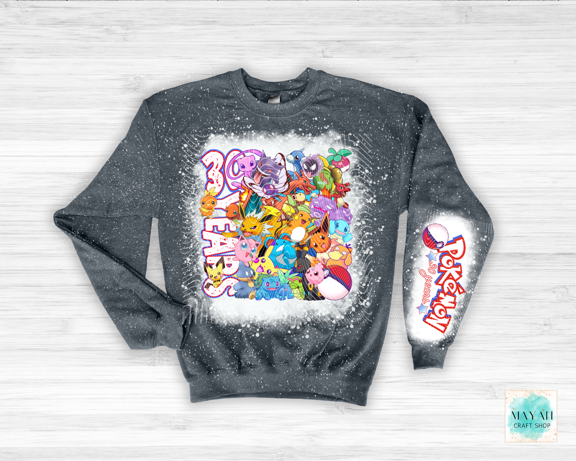 Gray sweatshirt with colorful graphic design on a light wooden background