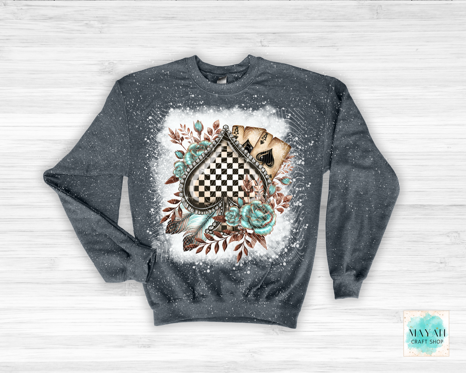 Gray sweatshirt with a decorative design on a white wooden background