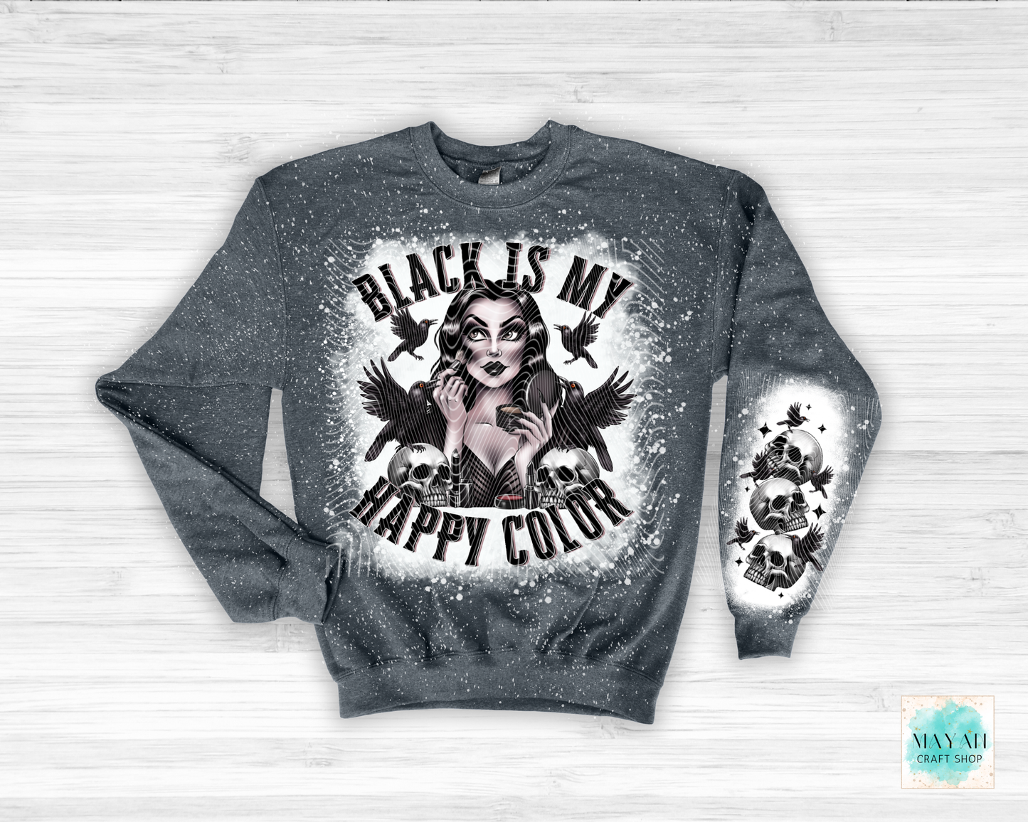 Gray sweatshirt with graphic design and text 'Black is my happy color' on a light wooden background.