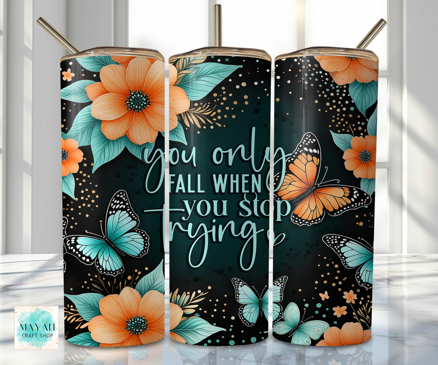 Three tumblers with floral and butterfly designs on a reflective surface.