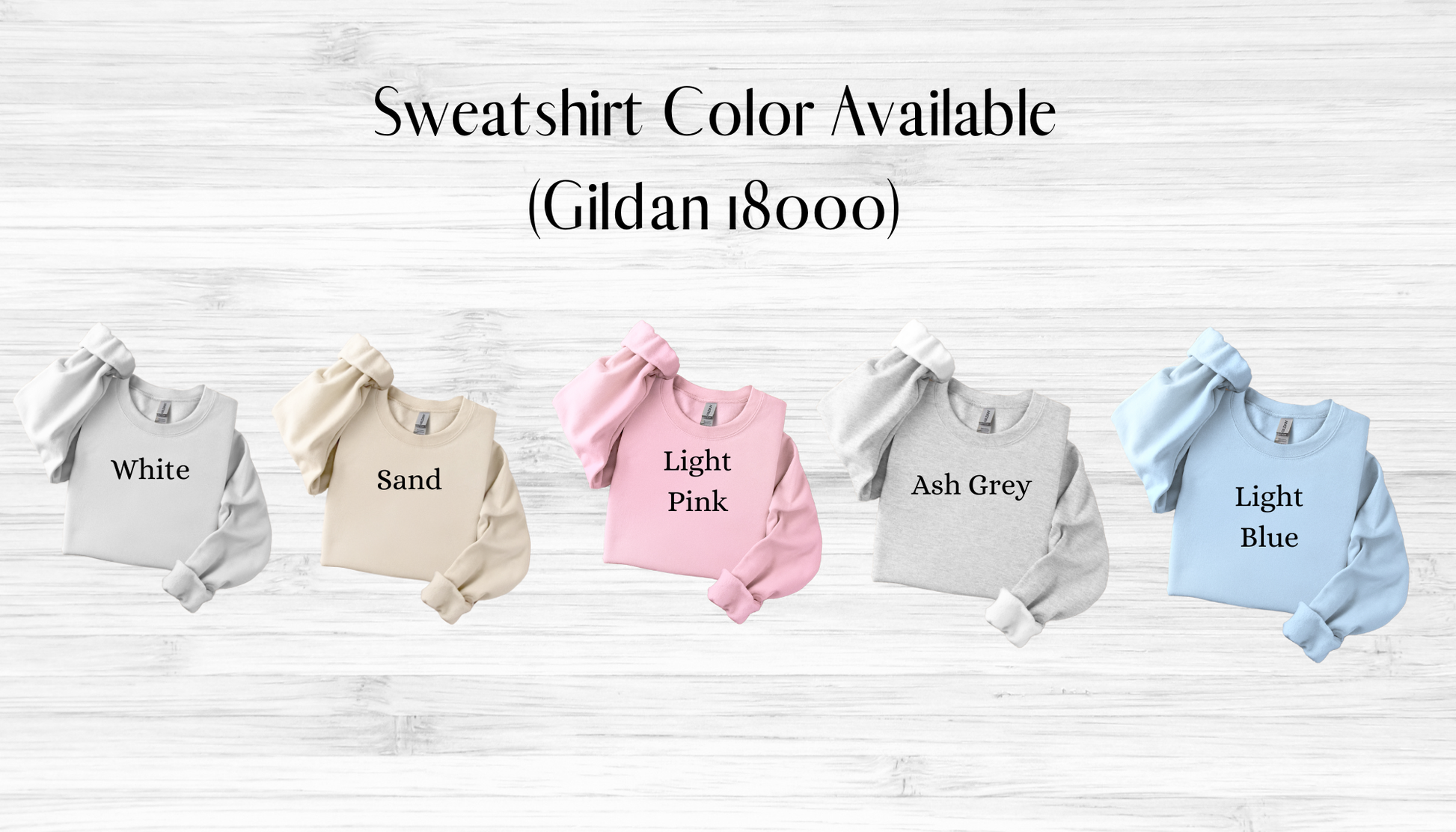 Five sweatshirts in different colors on a wooden surface with text indicating color options.